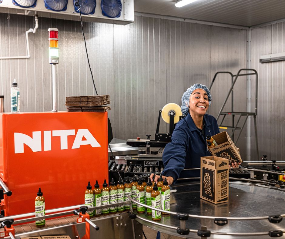 Women wearing navy blue lab coat while working in food processing facility